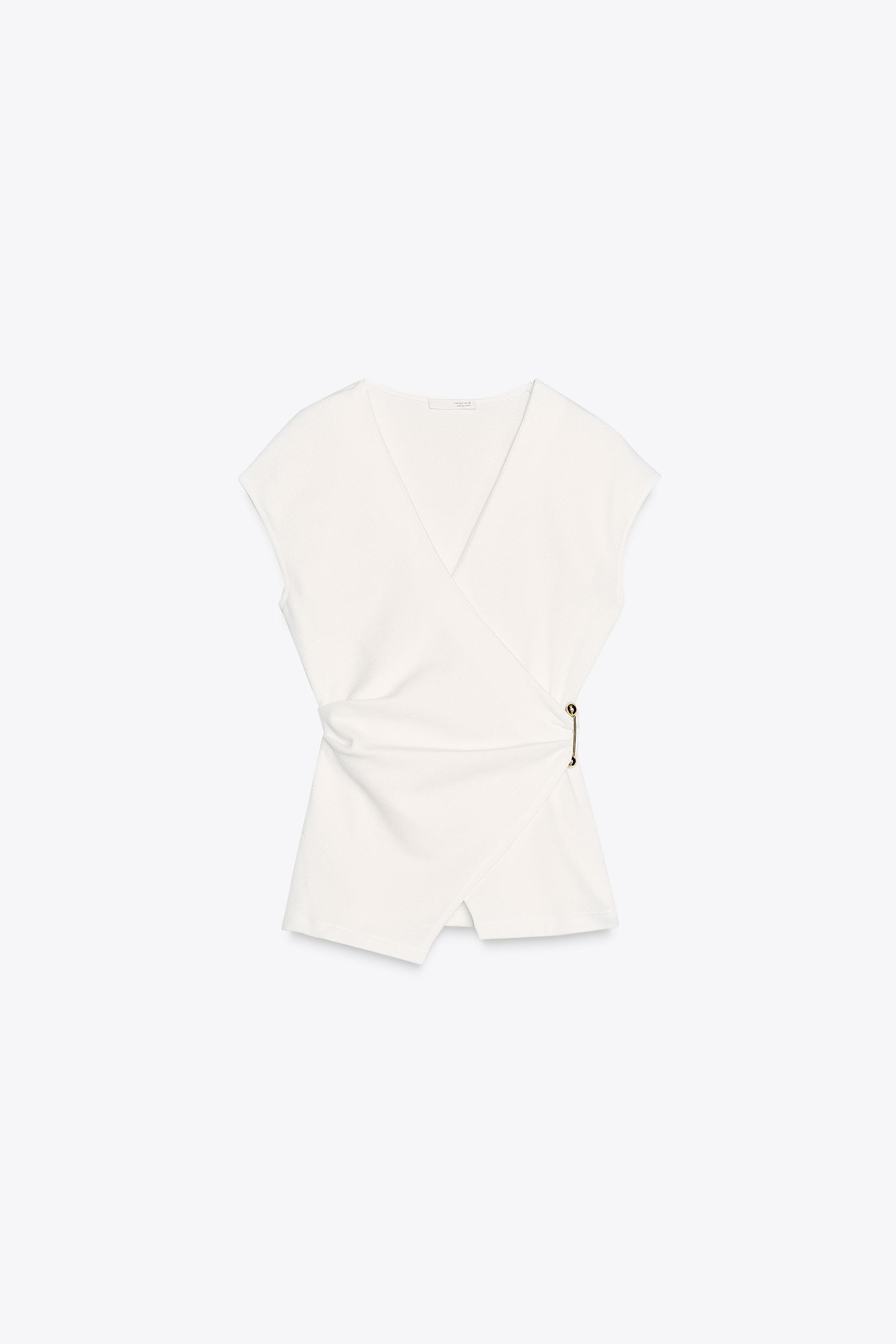 Textured top with brooch
