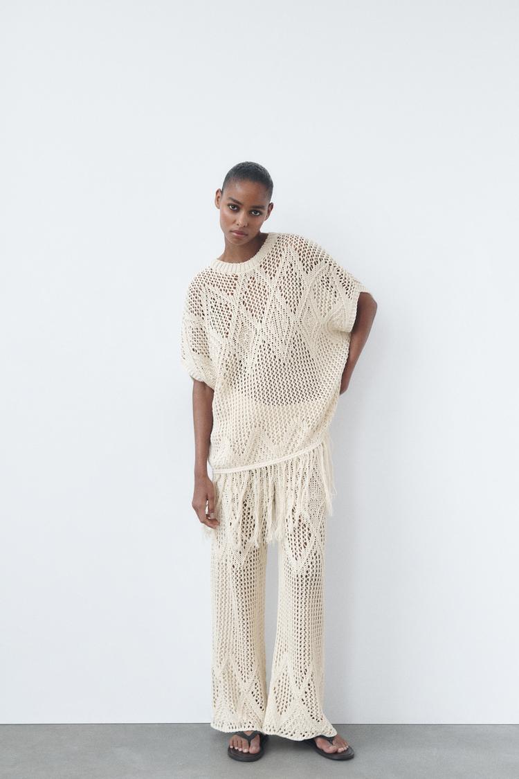 OPEN-KNIT TUNIC WITH FRINGING