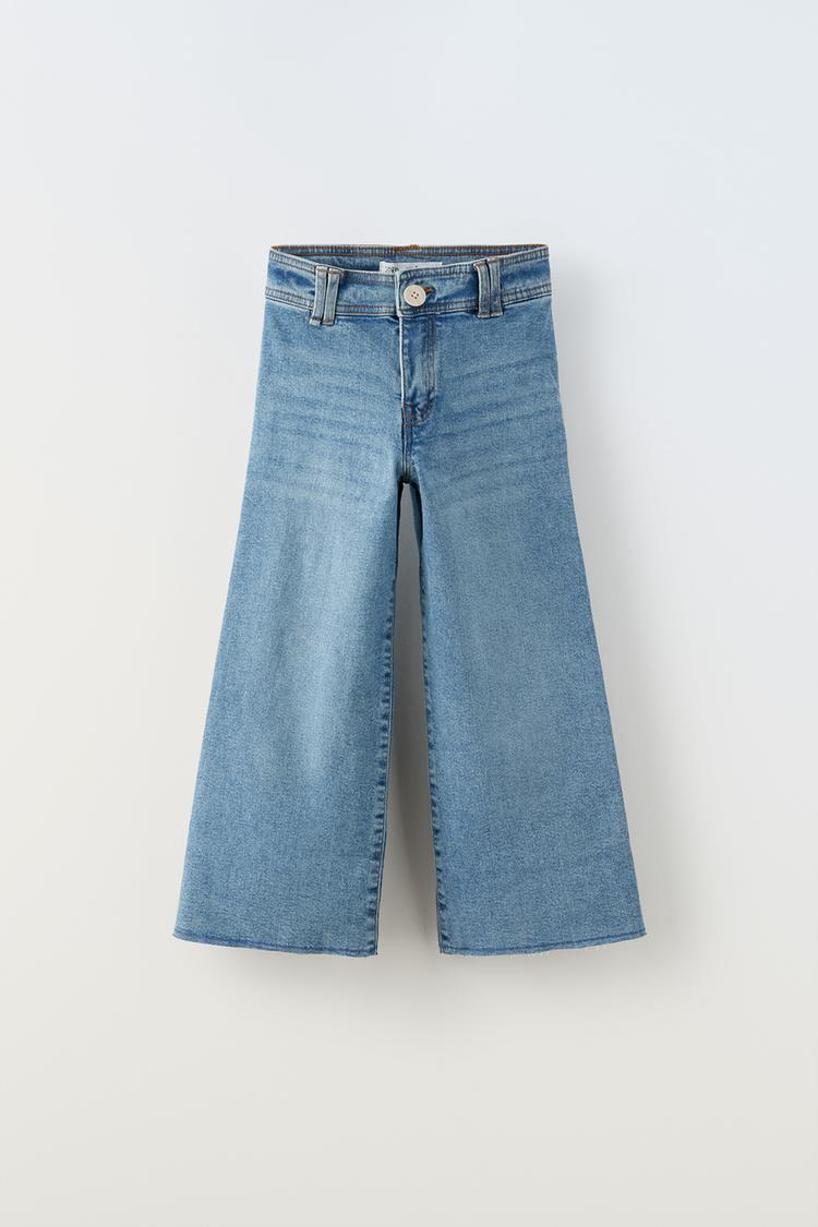 Jeans with adjustable interior waistband and front button closure. Back patch pockets.