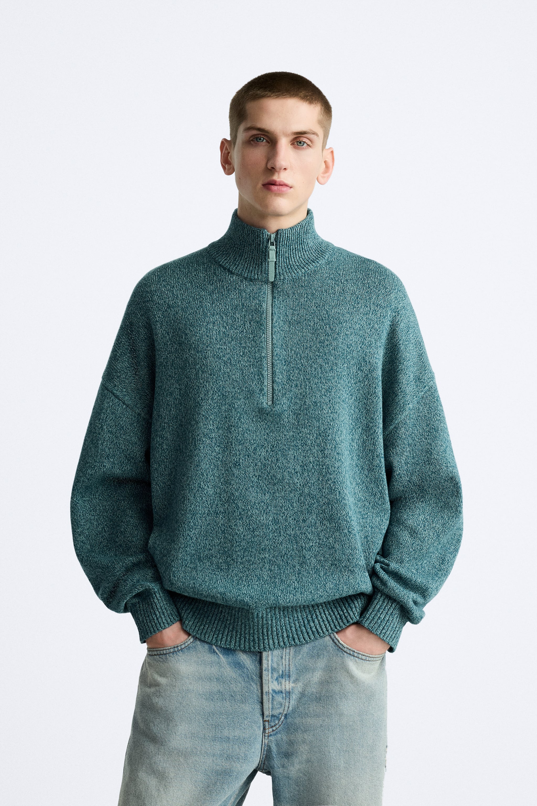 Mock neck sweater with front zip closure. Long sleeves. Rib trim.