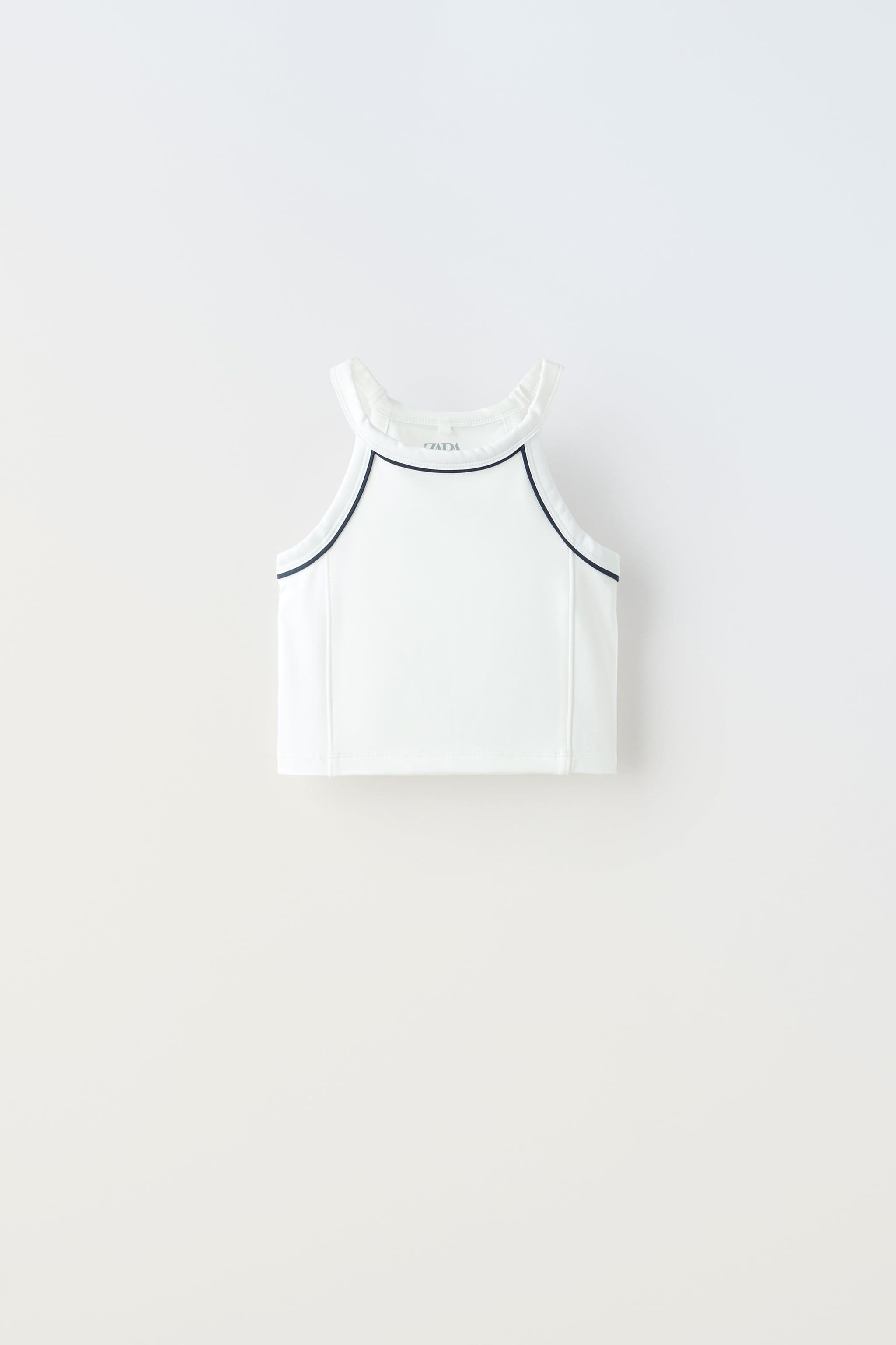 TECHNICAL FABRIC TOP WITH CONTRASTING PIPING