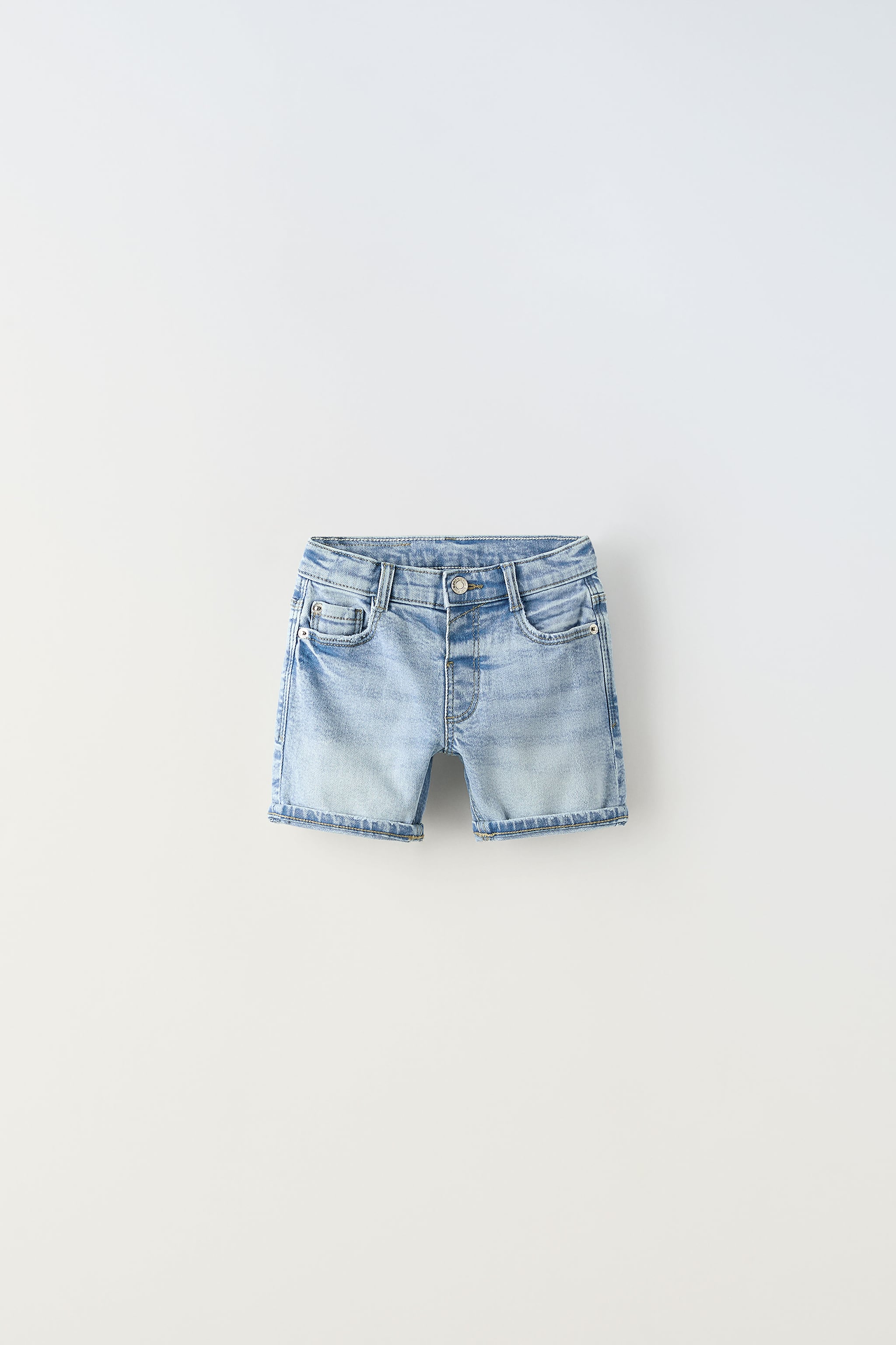 Shorts with interior adjustable waistband and Front button closure. pockets back patch pockets. Cuffed.