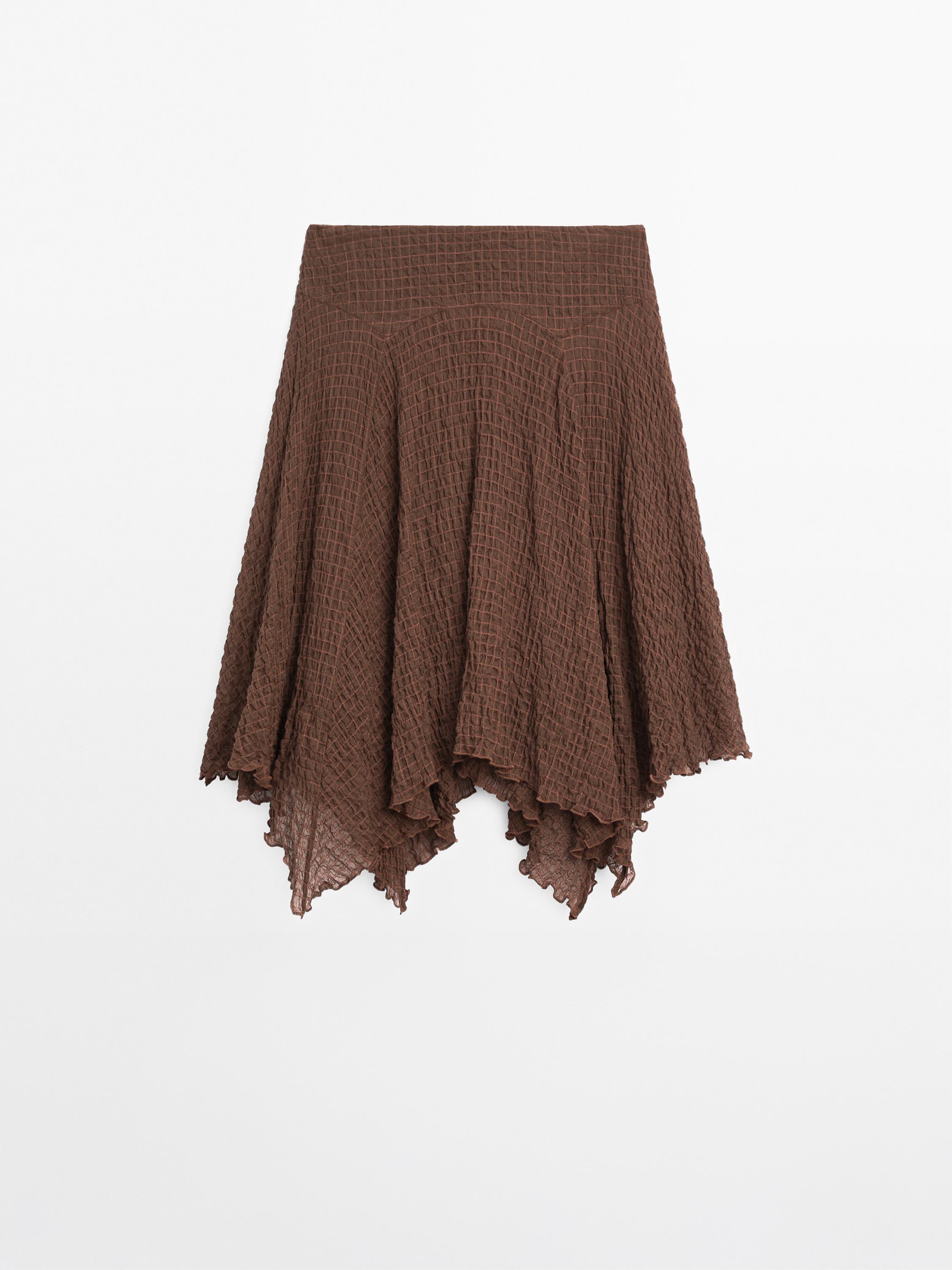 Flowing check skirt with asymmetric hem