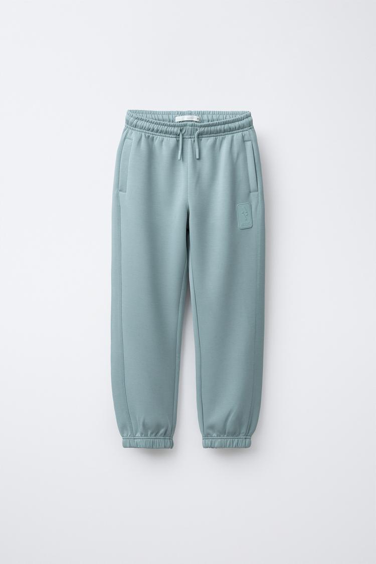 SPORTY JOGGER PANTS WITH RUBBERIZED LABEL - Zara product image