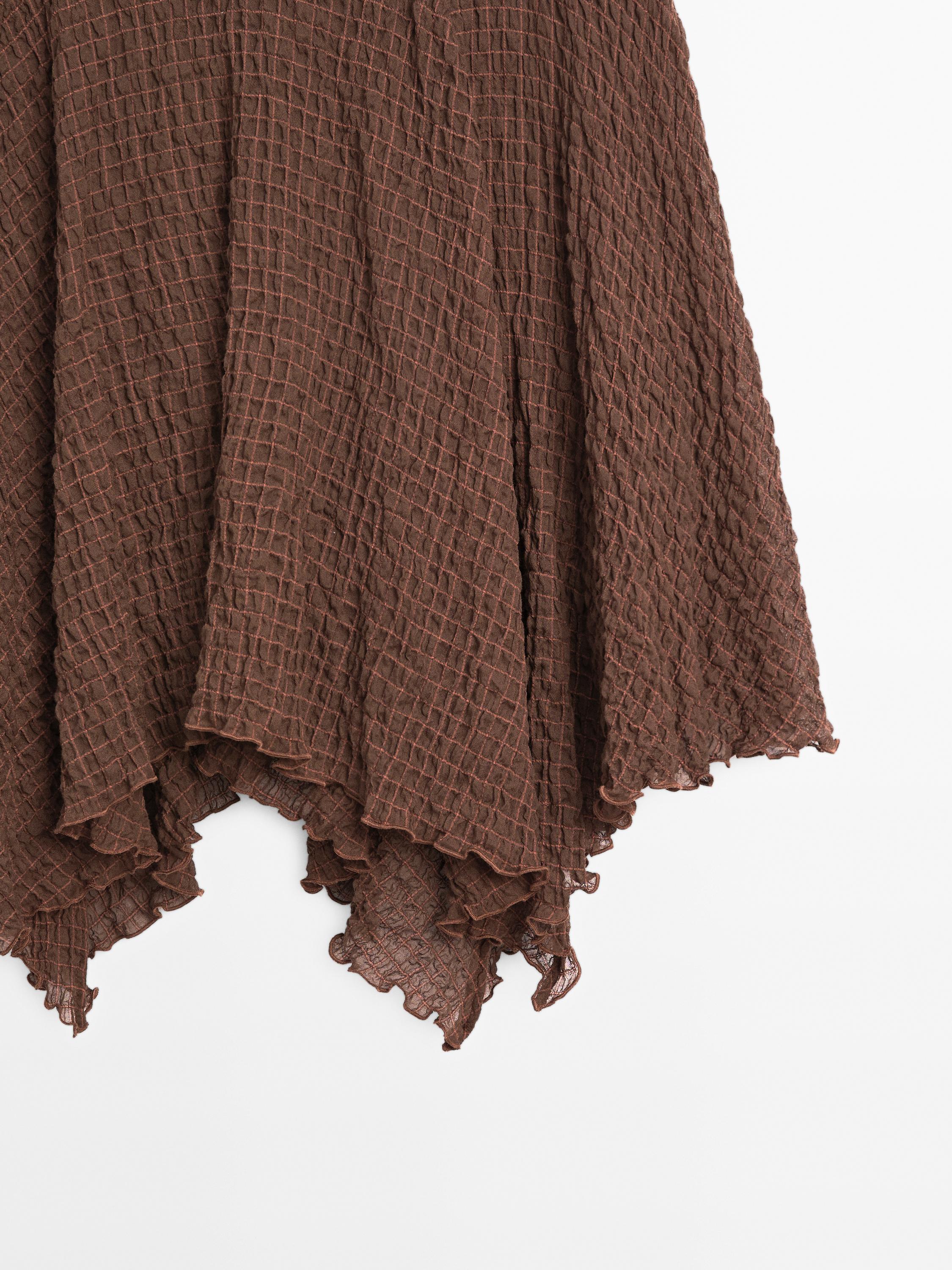Flowing check skirt with asymmetric hem